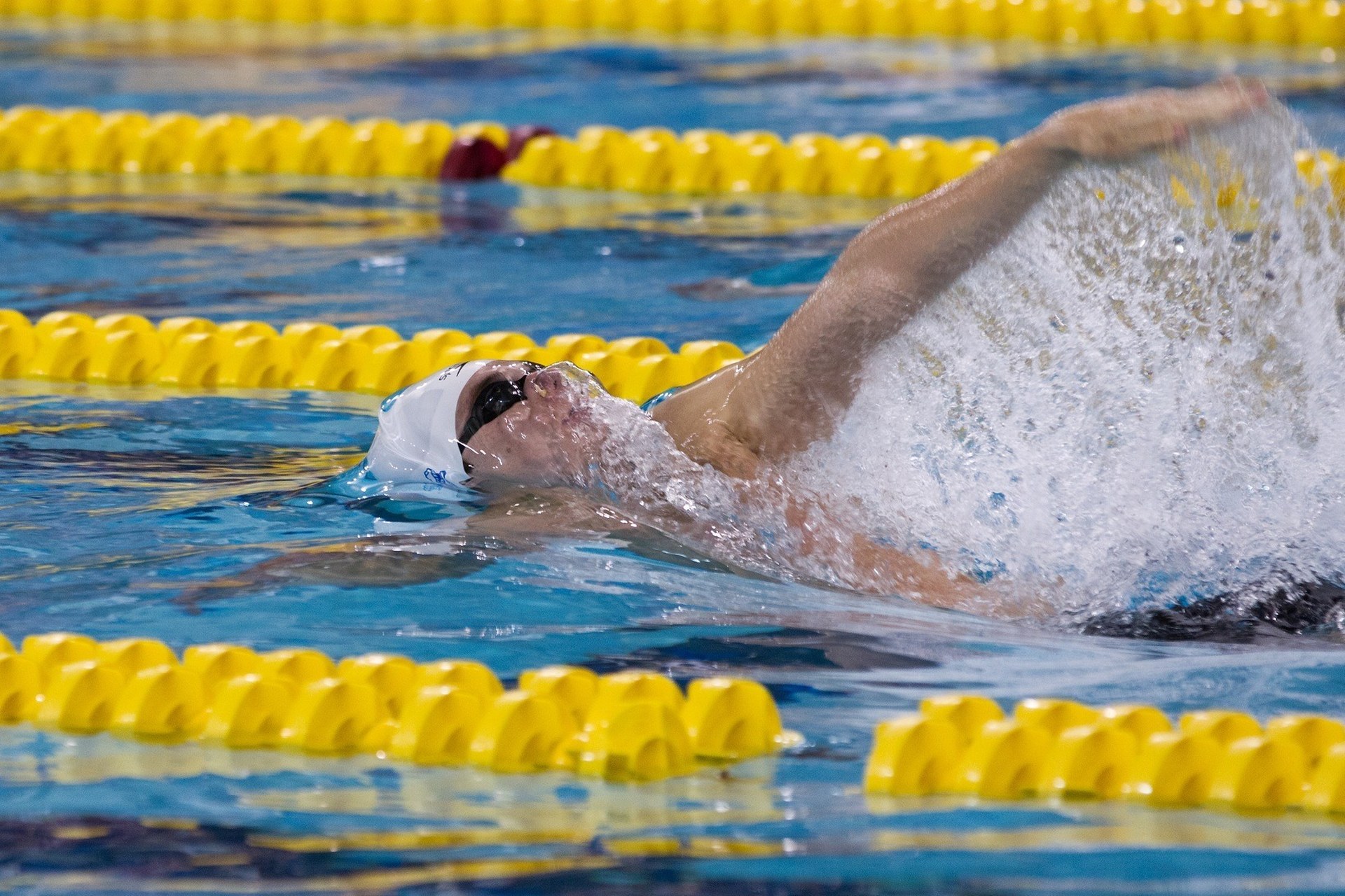 Marco Loughran swimming backstroke during a competition